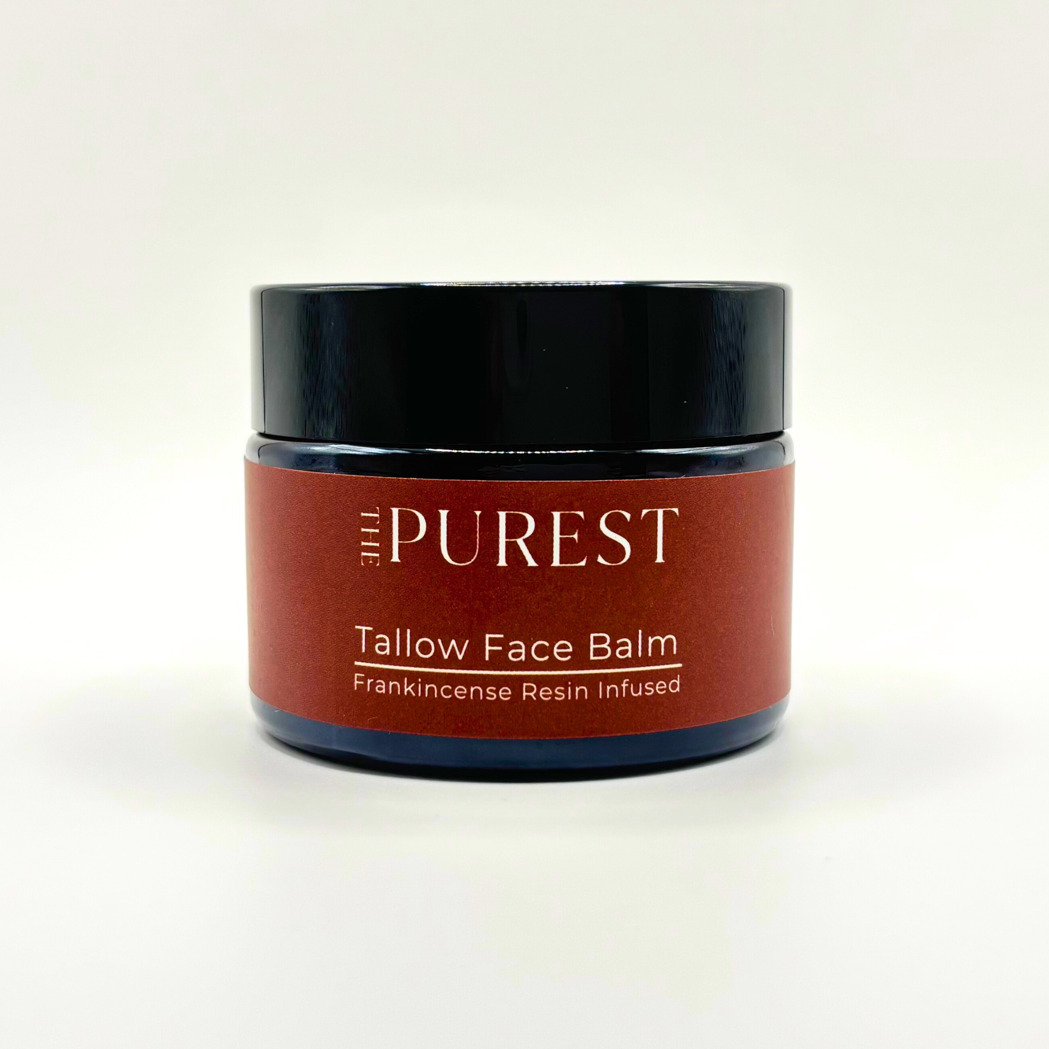 Jar of tallow face balm labeled 'The Purest' on a white background